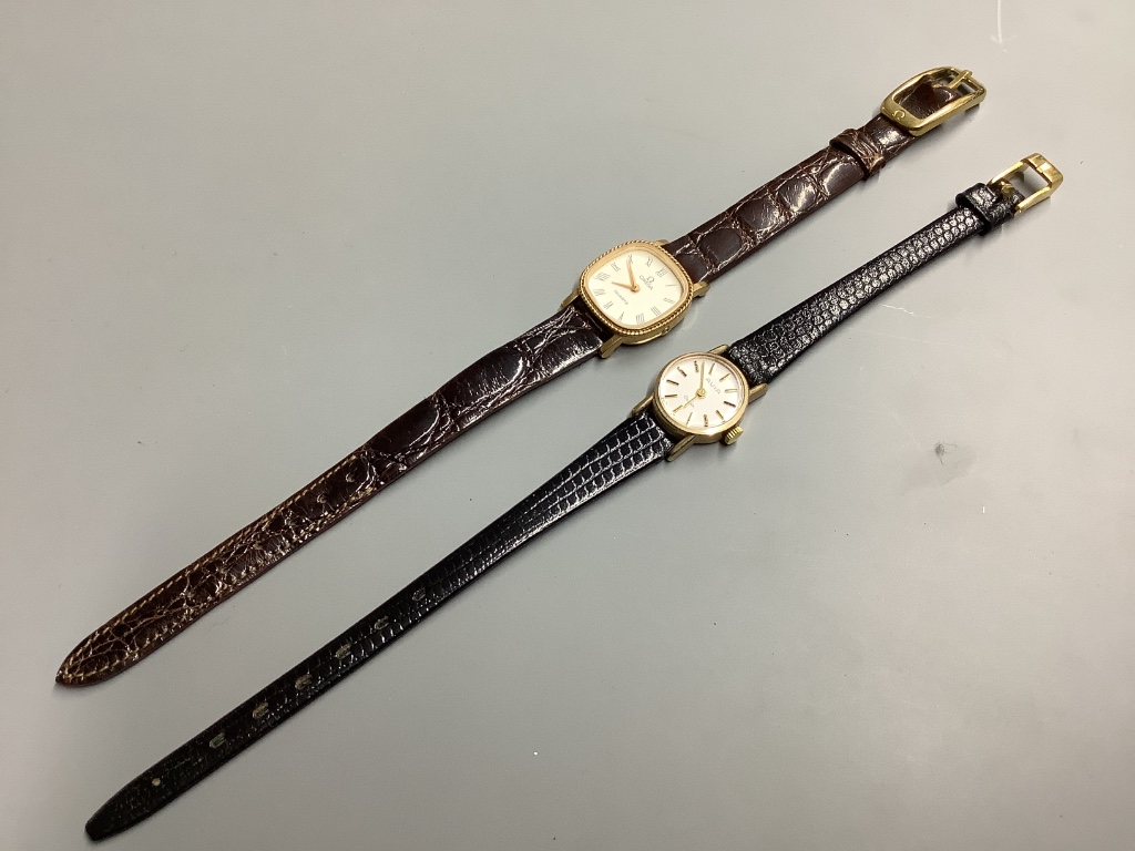 Two lady's modern 9ct gold quartz wrist watches, Omega and Avia, on leather straps, gross 19.3 grams.